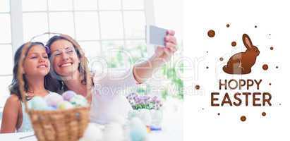 Composite image of happy mother and daughter taking selfie