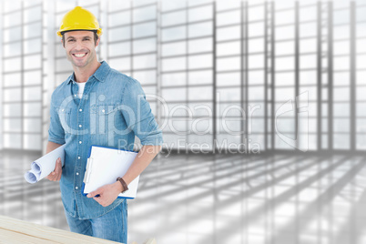 Composite image of happy carpenter holding rolled blueprint and