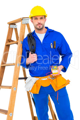 Electrician holding cables and multimeter