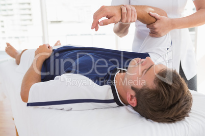 Doctor examining man arm