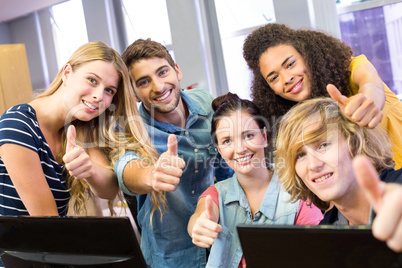 College students gesturing thumbs up