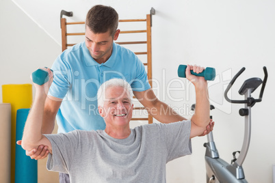 Senior man working out with his trainer