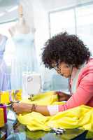 Fashion designer using sewing machine