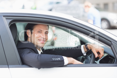 Happy businessman in the drivers seat