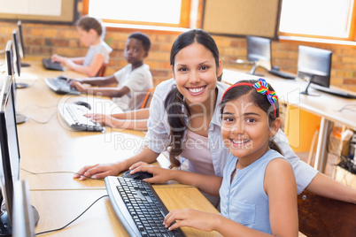 Cute pupils in computer class with teacher