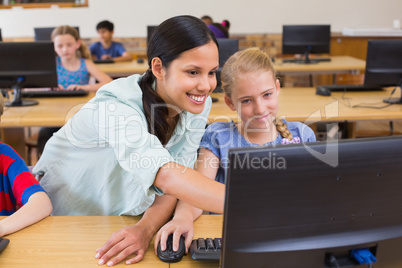 Cute pupils in computer class with teacher