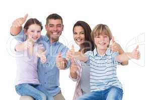 Happy family gesturing thumbs up