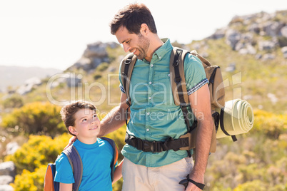 Father and son hiking through mountains