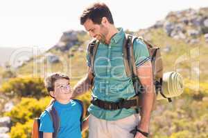 Father and son hiking through mountains