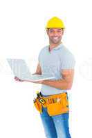 Portrait of happy repairman holding laptop