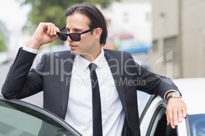 Businessman leaning on the door