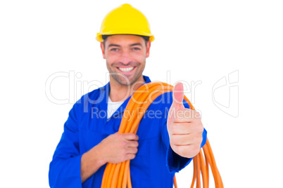 Electrician with rolled wire gesturing thumbs up