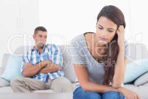 Angry woman sitting in front of man