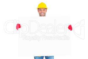 Portrait of handyman showing blank placard