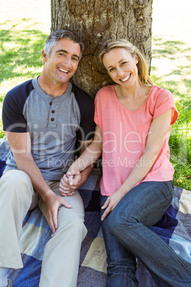 Happy couple relaxing in the park Happy couple relaxing in the park