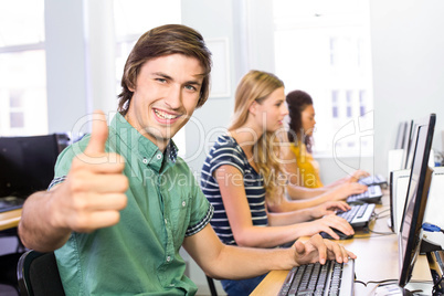 Student gesturing thumbs up in computer class