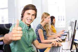 Student gesturing thumbs up in computer class