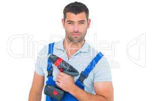 Portrait of confident carpenter holding power drill