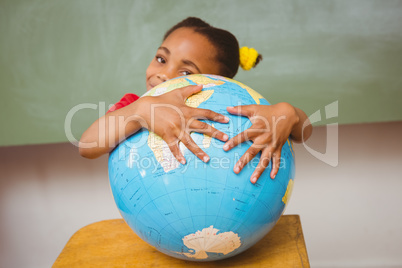 Cute little girl holding globe