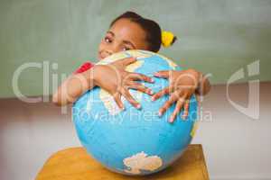 Cute little girl holding globe