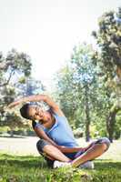 Fit woman stretching in the park