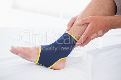 Man touching his injured foot