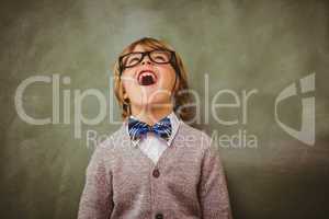 Boy laughing in front of blackboard