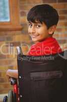 Boy sitting in wheelchair in school