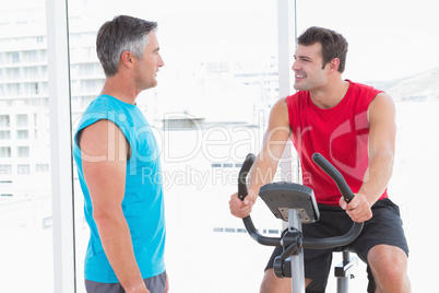 Trainer with man on exercise bike