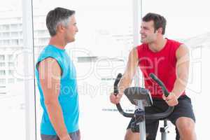 Trainer with man on exercise bike