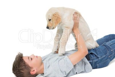 Boy playing with puppy