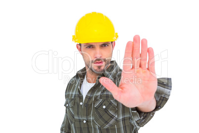 Confident manual worker gesturing stop sign