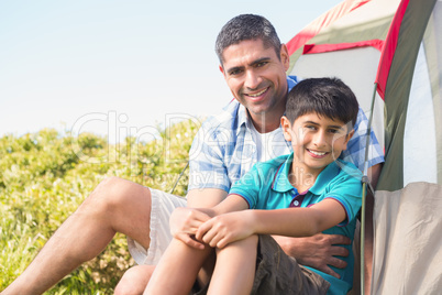 Father and son beside their tent