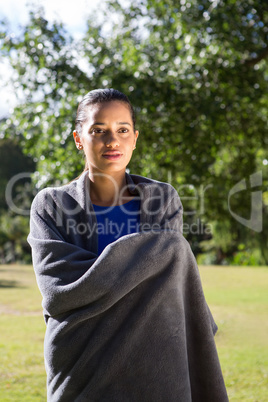 Pretty woman wrapped in blanket