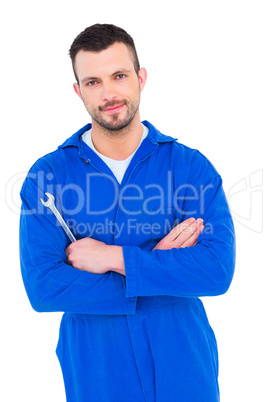 Smiling male mechanic holding spanner