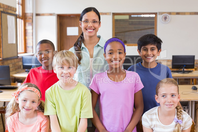 Cute pupils in computer class with teacher