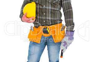 Manual worker wearing tool belt while holding gloves and helmet