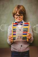 Portrait of cute little boy holding abacus