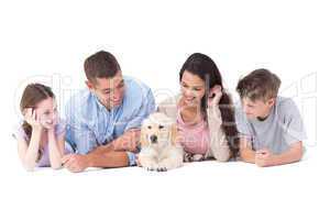 Family looking at puppy while lying