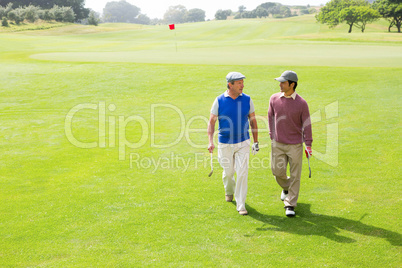 Golfer friends walking and chatting