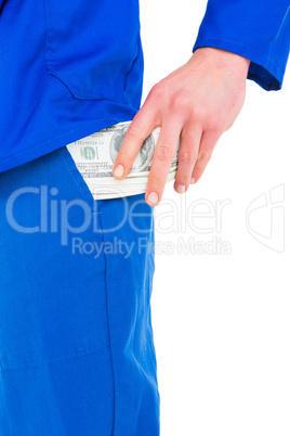 Handyman putting money in his pocket