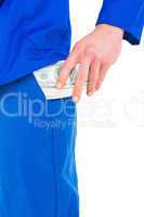 Handyman putting money in his pocket