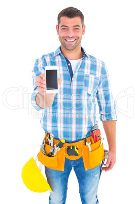 Portrait of smiling handyman showing mobile phone