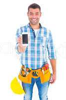 Portrait of smiling handyman showing mobile phone
