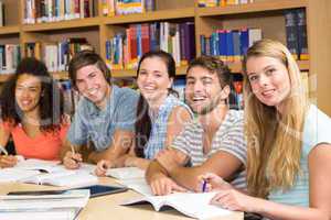 College students doing homework in library