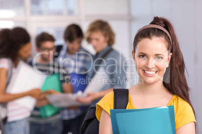 Female student holding folder in college