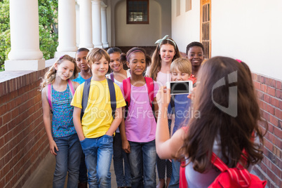 Cute pupils using mobile phone