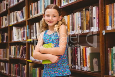 Girl holding book in library