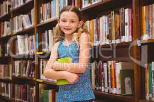 Girl holding book in library