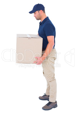 Side view of delivery man carrying cardboard box